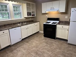 a kitchen with granite countertop a stove a sink and a granite counter tops