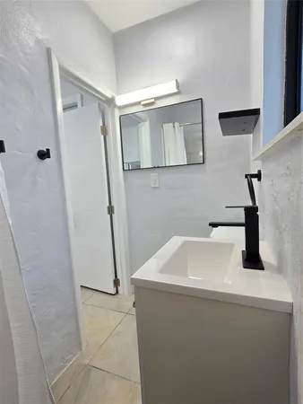 a white toilet sitting next to a bathroom sink