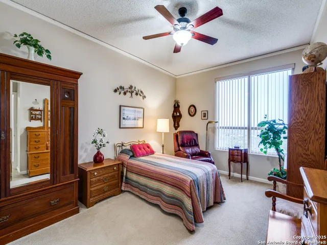 a bedroom with a bed and a potted plant