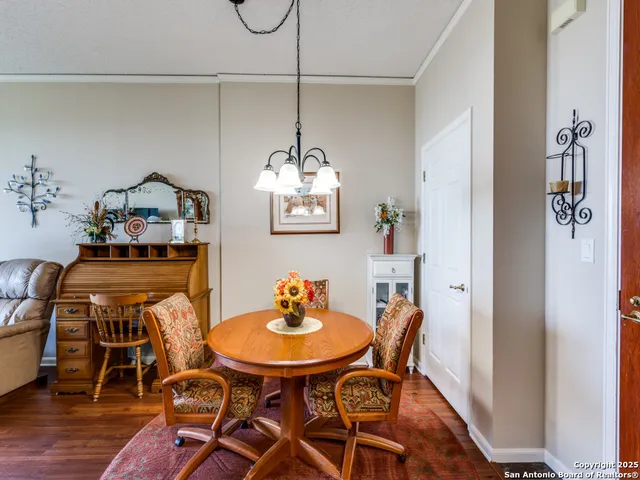 a view of a dining room with furniture wooden floor and chandelier