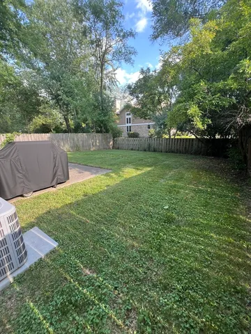 a view of a yard with a house in the background