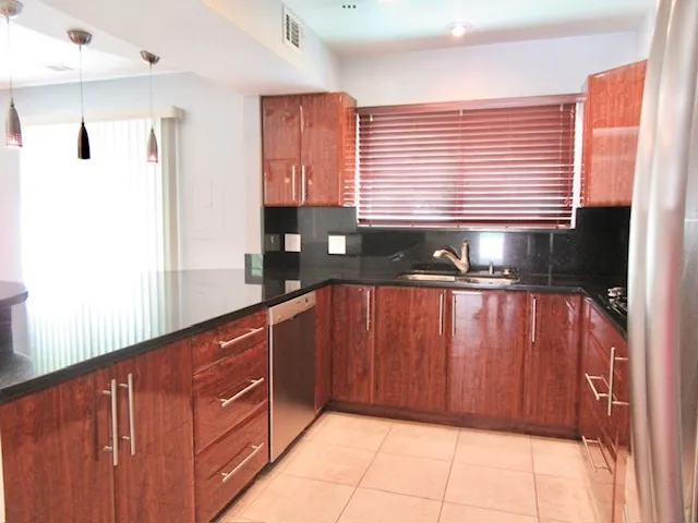 a kitchen with wooden cabinets and a sink