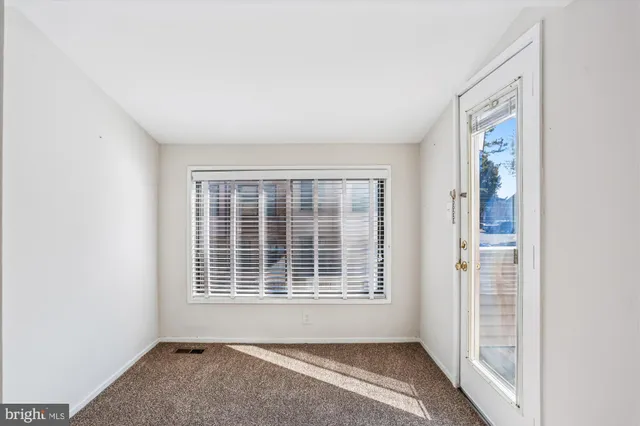 a view of a hallway with wooden shelves