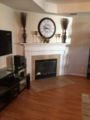 1784 Old Ranch Road Fort Walton Beach, FL 32547 - Photo 13 of 16 a living room with a fireplace and a television
