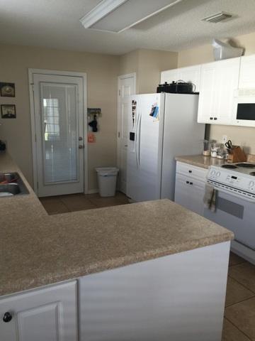 1784 Old Ranch Road Fort Walton Beach, FL 32547 - Photo 3 of 16 a kitchen with a refrigerator a stove a sink and cabinets