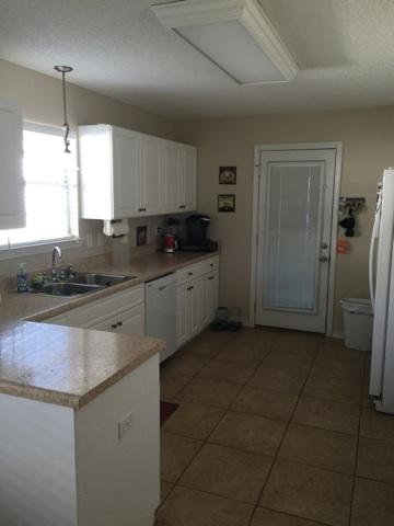 1784 Old Ranch Road Fort Walton Beach, FL 32547 - Photo 4 of 16 a kitchen with stainless steel appliances granite countertop a sink a stove a refrigerator and island