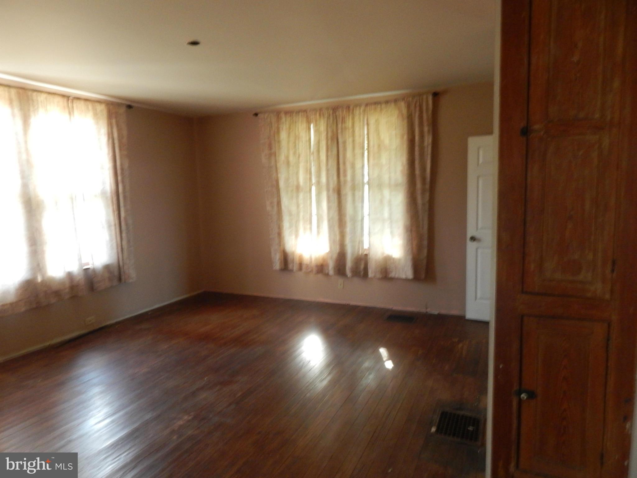 2443 Rocks Road Forest Hill, MD 21050 - Photo 5 of 21 a view of an empty room with wooden floor and a window