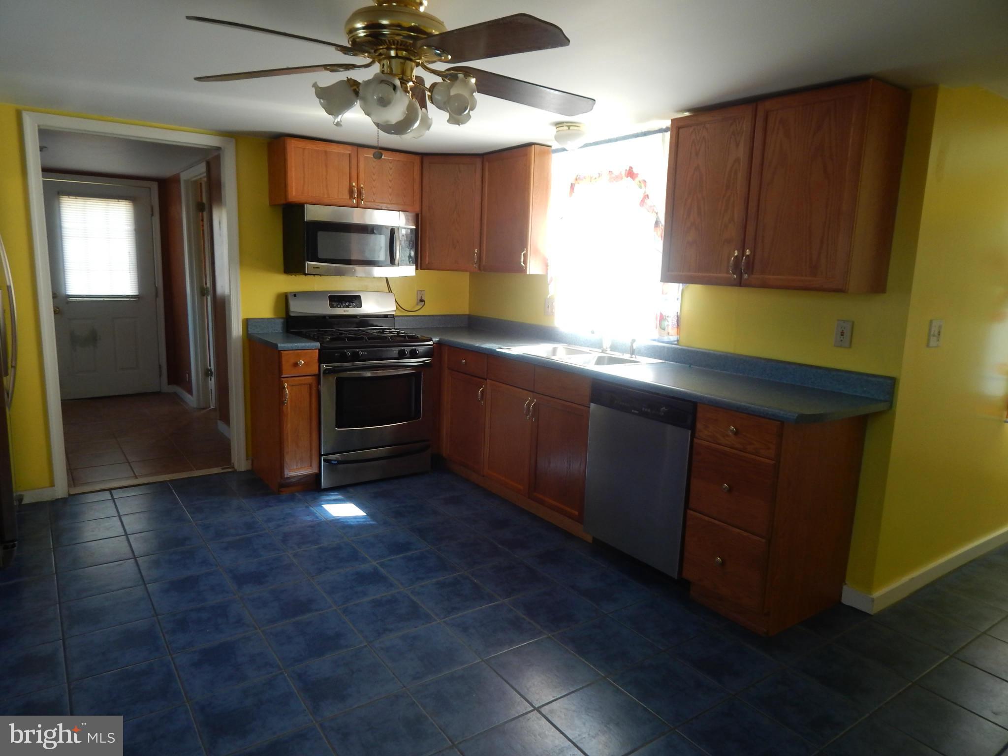 2443 Rocks Road Forest Hill, MD 21050 - Photo 6 of 21 a kitchen with stainless steel appliances granite countertop wooden cabinets a stove top oven a sink and dishwasher