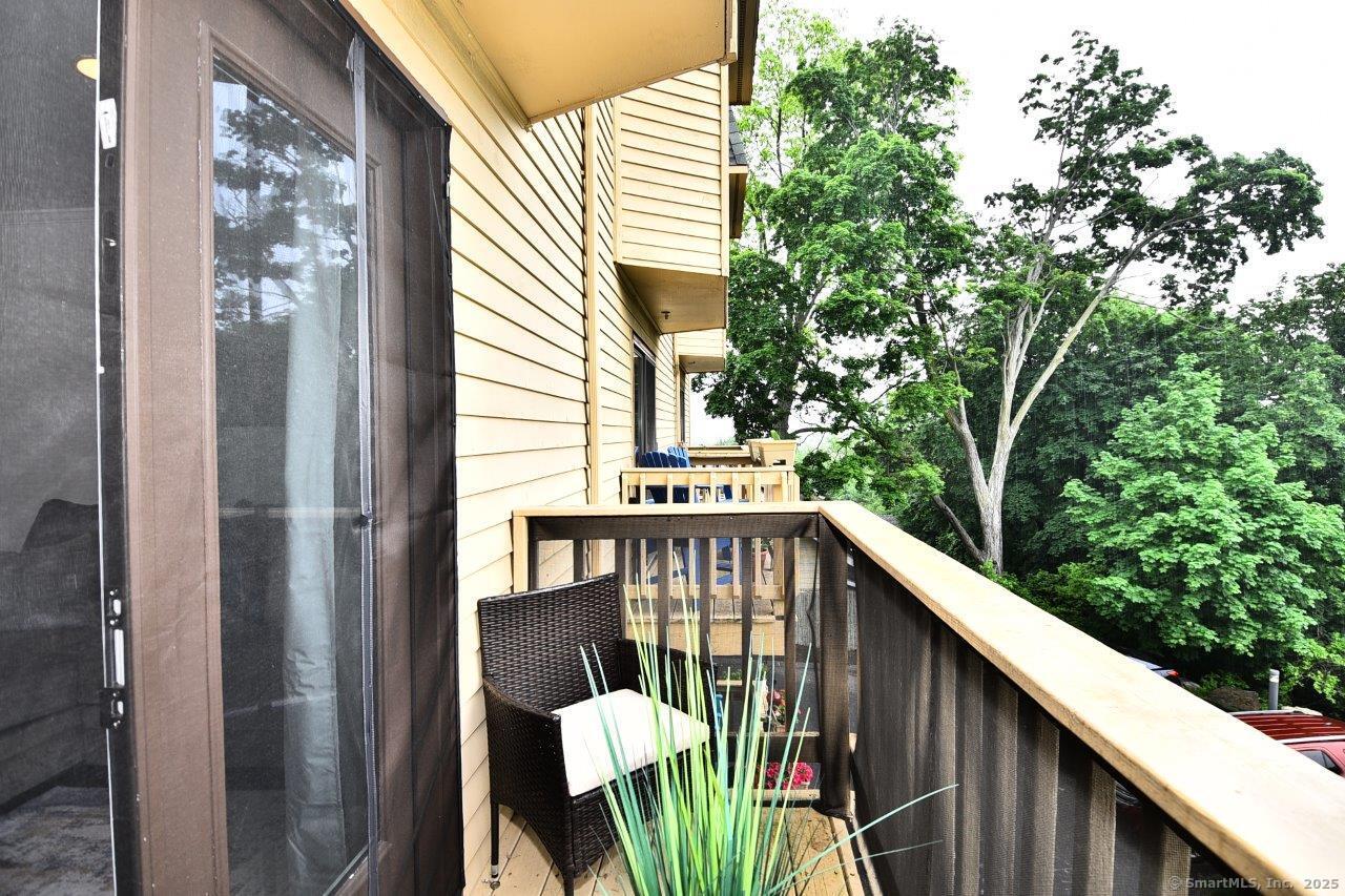 178 Flax Hill Road, Unit C203 Norwalk, CT 06854 - Photo 12 of 35 a balcony with wooden floor stairs and outdoor seating