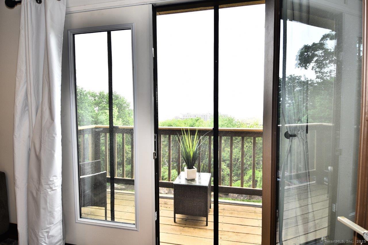 178 Flax Hill Road, Unit C203 Norwalk, CT 06854 - Photo 13 of 35 a view of a glass door and a yard from a window