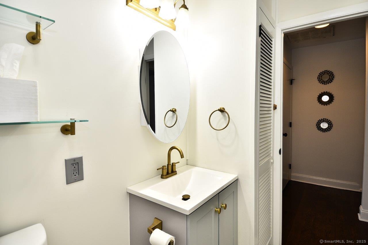 178 Flax Hill Road, Unit C203 Norwalk, CT 06854 - Photo 15 of 35 a bathroom with a sink a toilet a mirror and shower