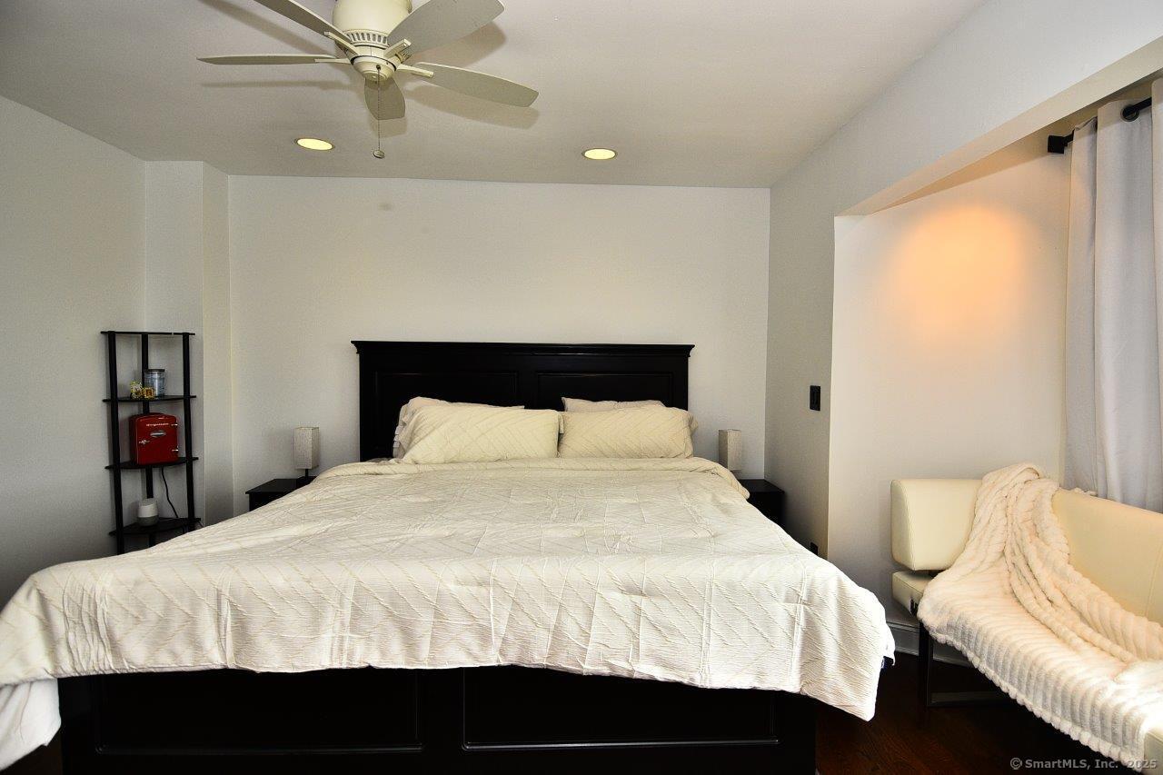 178 Flax Hill Road, Unit C203 Norwalk, CT 06854 - Photo 20 of 35 a bedroom with a bed and wooden floor