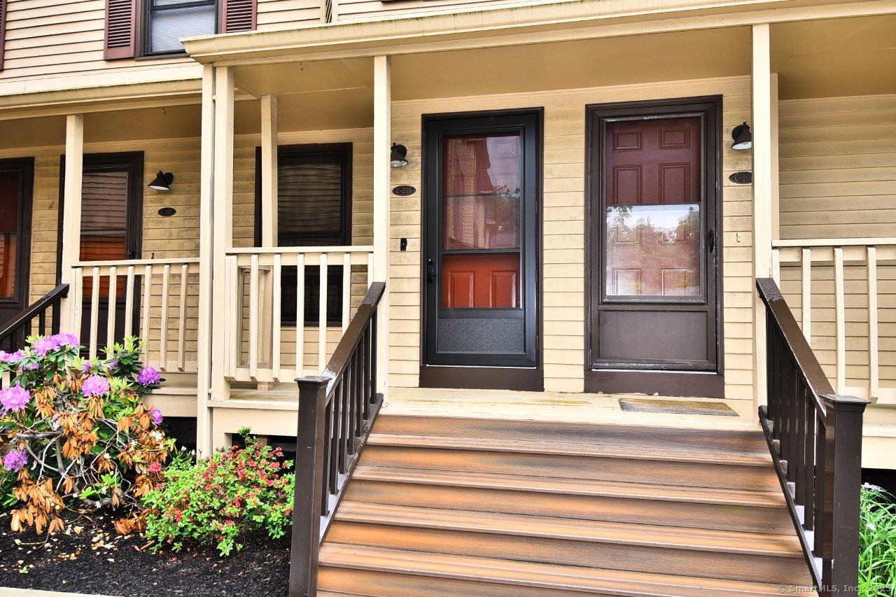 178 Flax Hill Road, Unit C203 Norwalk, CT 06854 - Photo 2 of 35 a front view of a house with a porch
