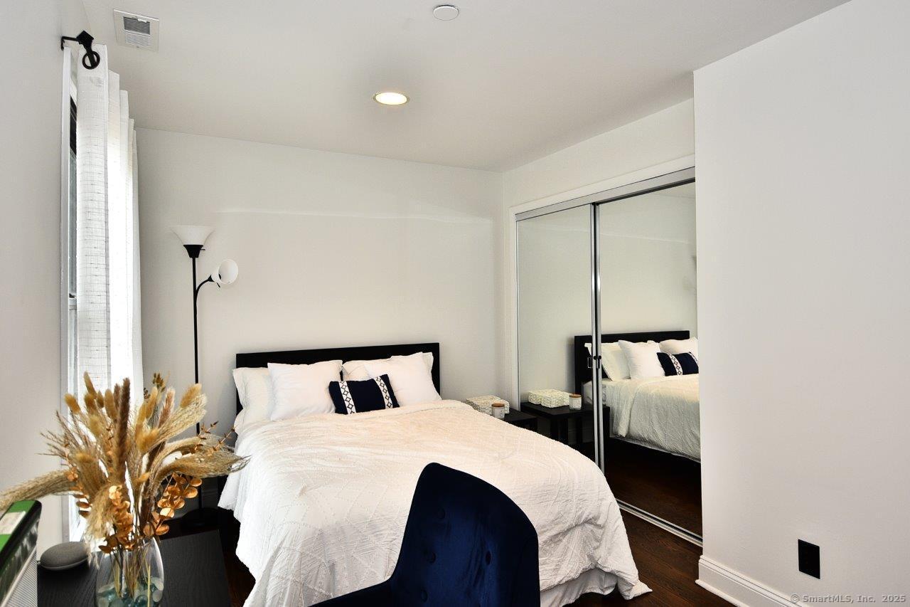 178 Flax Hill Road, Unit C203 Norwalk, CT 06854 - Photo 22 of 35 a bedroom with a bed and a potted plant