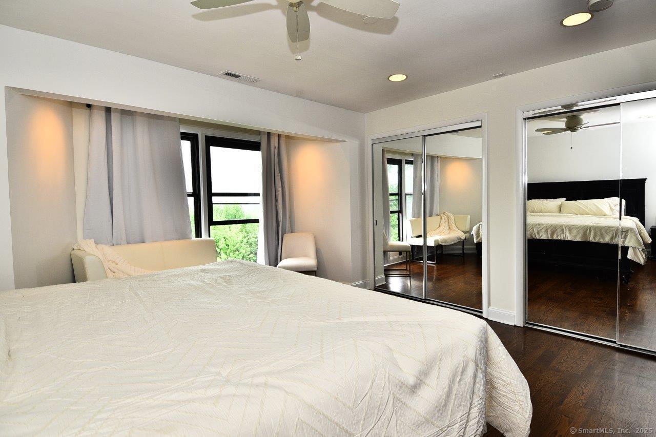 178 Flax Hill Road, Unit C203 Norwalk, CT 06854 - Photo 23 of 35 a bedroom with a bed and a large window