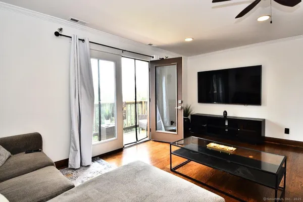 a kitchen with stainless steel appliances granite countertop a sink a stove and a refrigerator with wooden floor