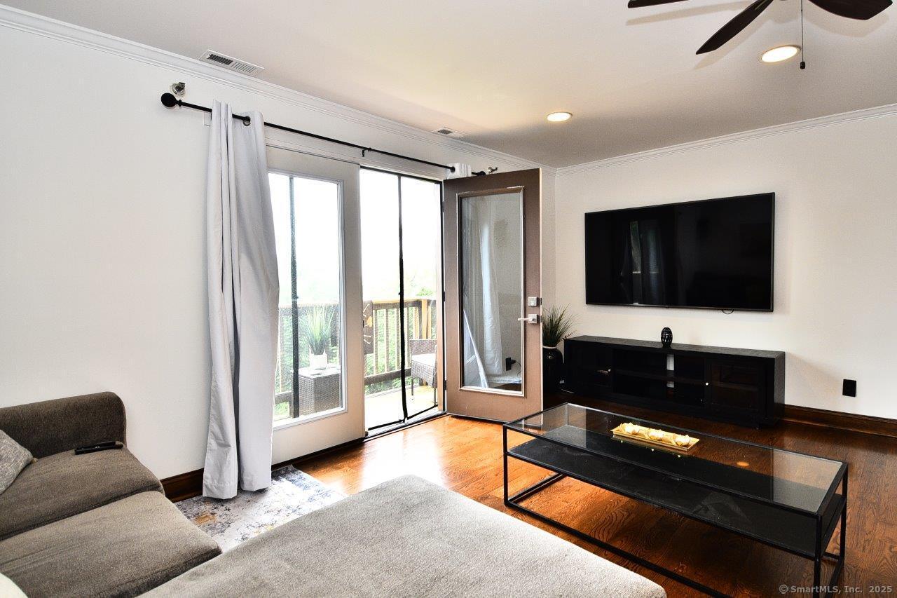 178 Flax Hill Road, Unit C203 Norwalk, CT 06854 - Photo 7 of 35 a living room with furniture and a flat screen tv