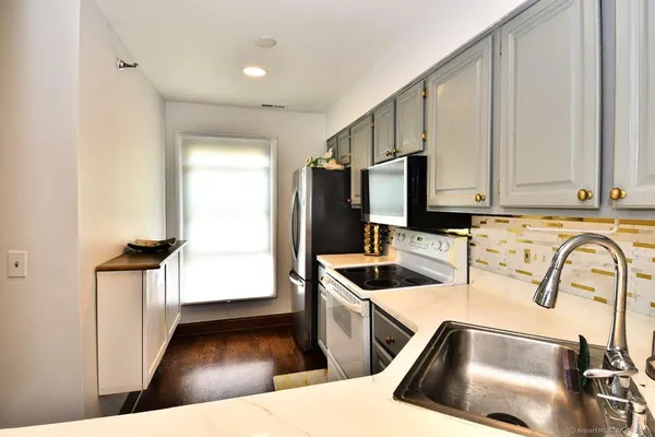 a kitchen with stainless steel appliances a refrigerator stove and microwave