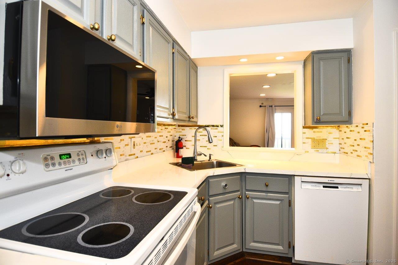 178 Flax Hill Road, Unit C203 Norwalk, CT 06854 - Photo 10 of 35 a bathroom with a sink a toilet and a mirror