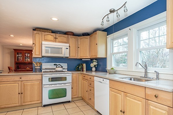 18 Proctor Road Chelmsford, MA 01824 - Photo 3 of 30 a kitchen with granite countertop a sink cabinets stainless steel appliances and a window