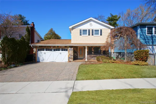 a front view of a house with a garden and porch