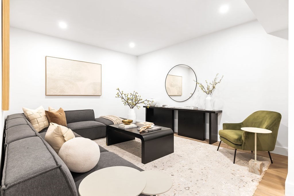 40 Otis, Unit L Needham, MA 02492 - Photo 17 of 19 a living room with furniture a rug and a fireplace