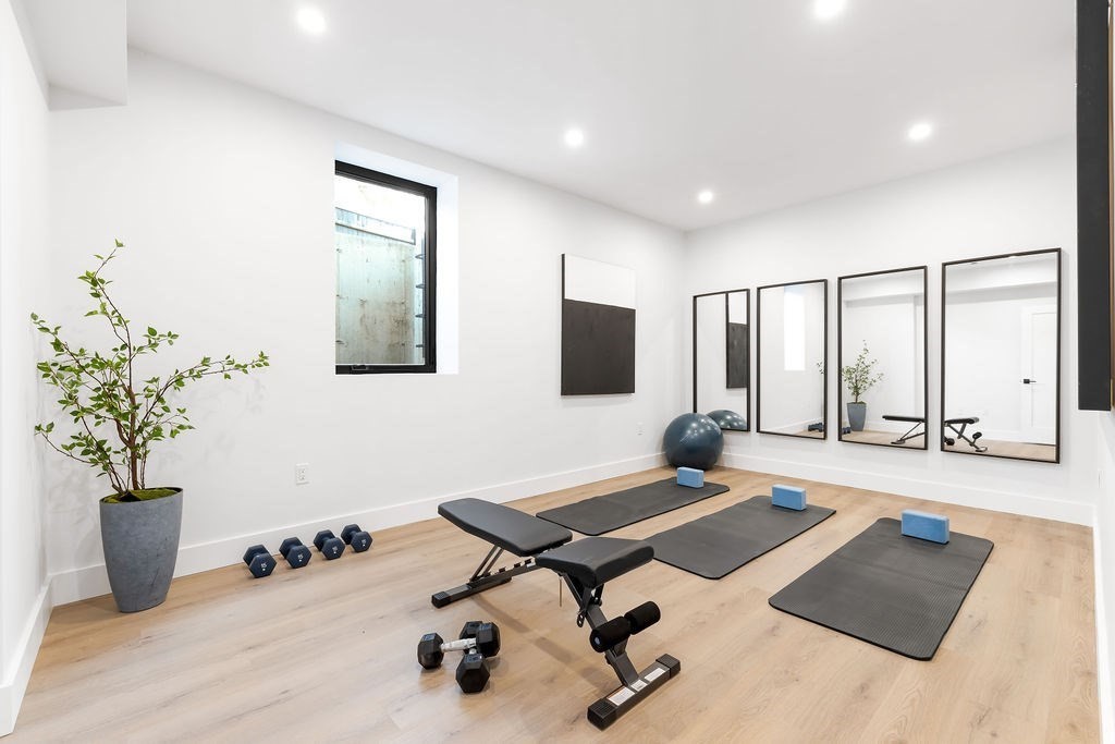 40 Otis, Unit L Needham, MA 02492 - Photo 18 of 19 a living room with a couch and potted plant