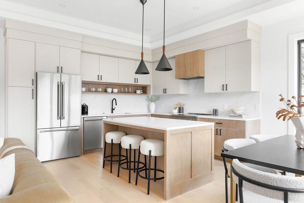 40 Otis, Unit L Needham, MA 02492 - Photo 4 of 19 a kitchen with stainless steel appliances granite countertop a sink a stove a refrigerator and island with wooden floor