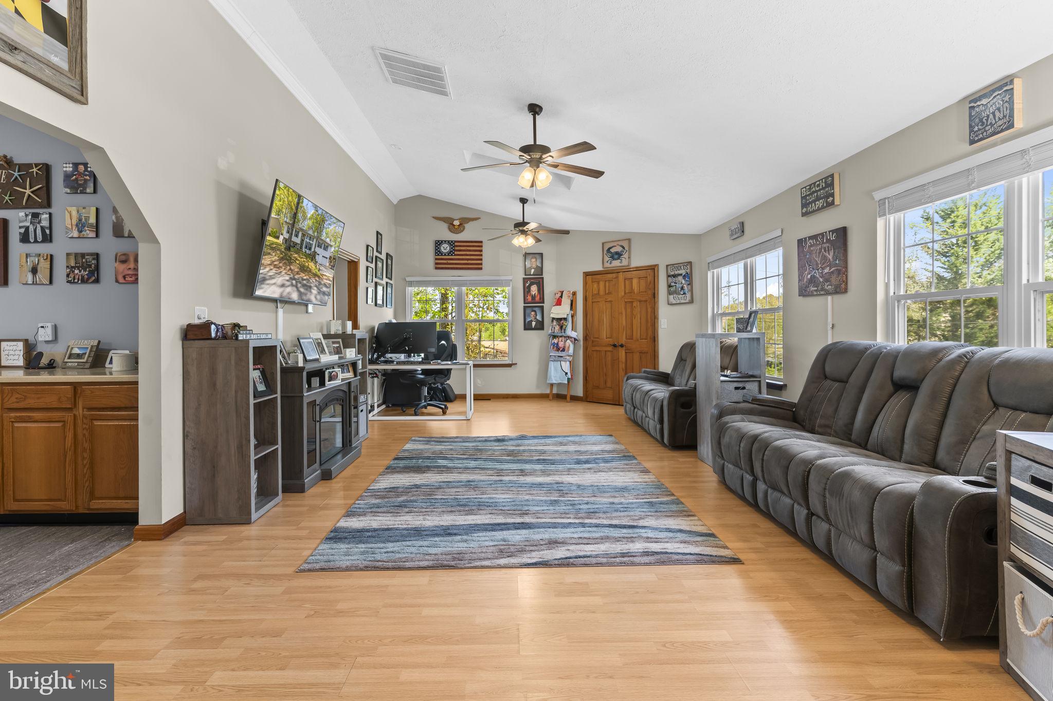 205 Pawnee Lane Lusby, MD 20657 - Photo 11 of 37 a large living room with stainless steel appliances granite countertop furniture wooden floor and a large window