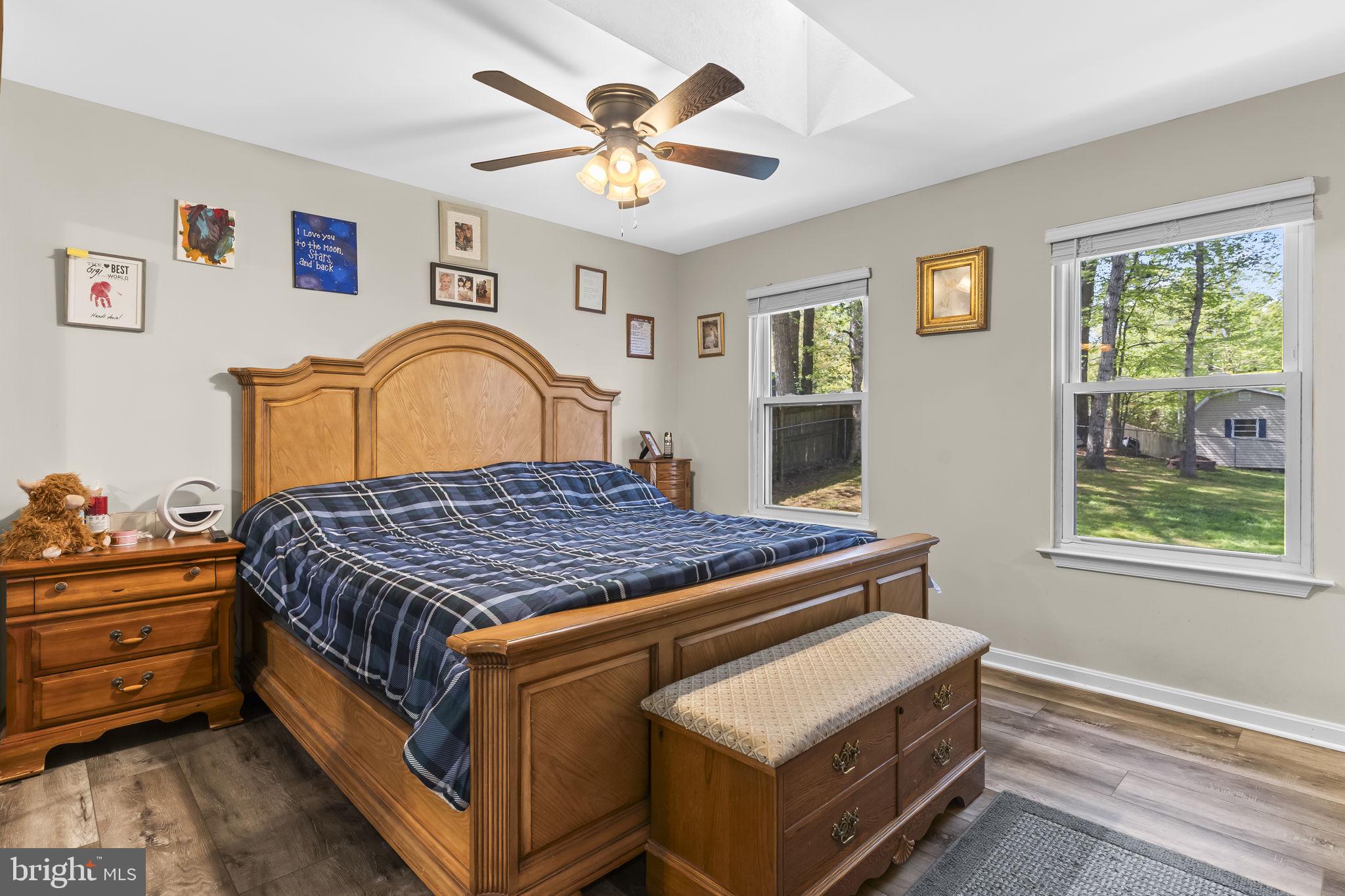 205 Pawnee Lane Lusby, MD 20657 - Photo 16 of 37 a bed sitting in a bedroom next to a window