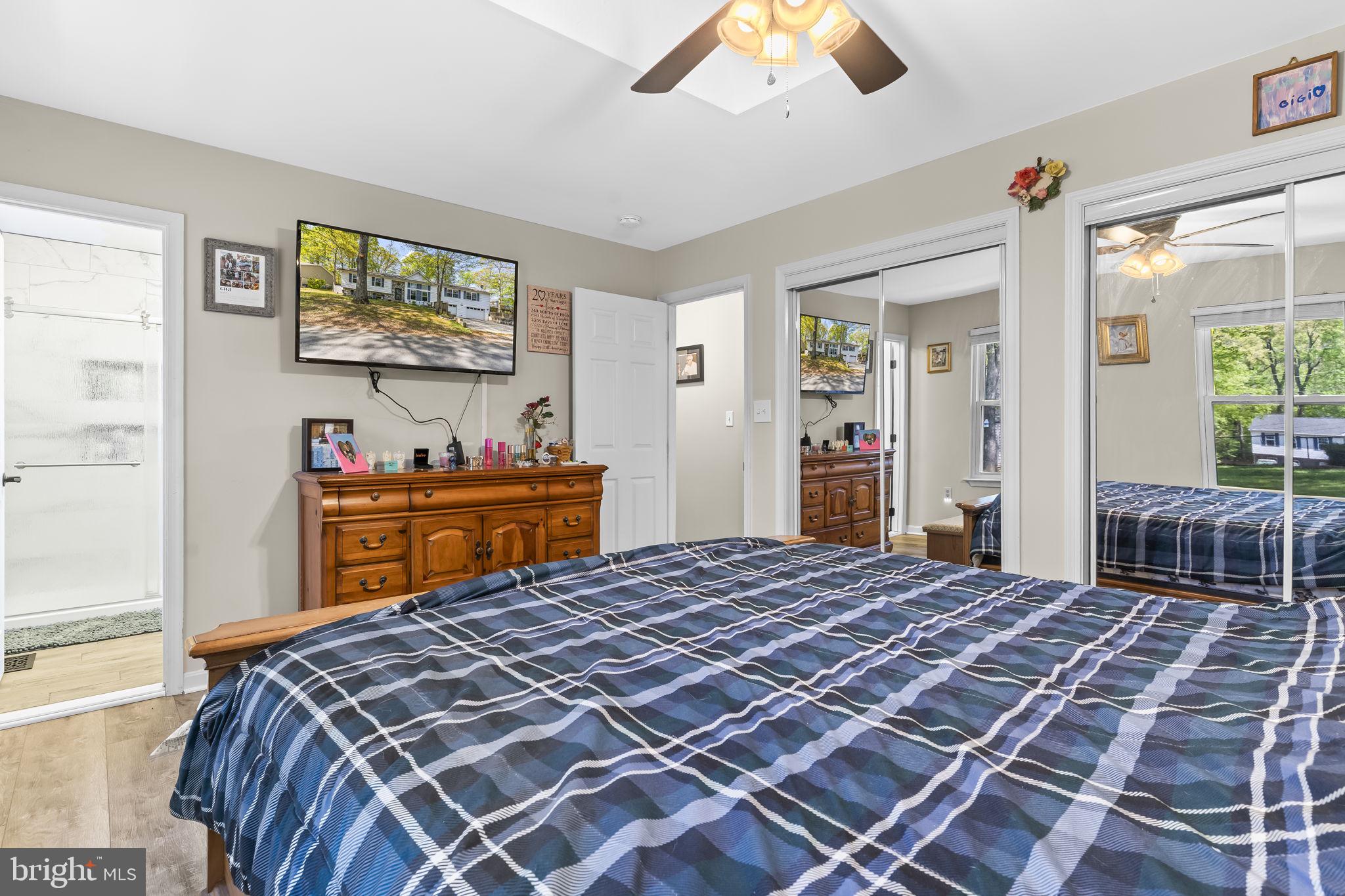 205 Pawnee Lane Lusby, MD 20657 - Photo 17 of 37 a bedroom with a bed and dresser with mirror