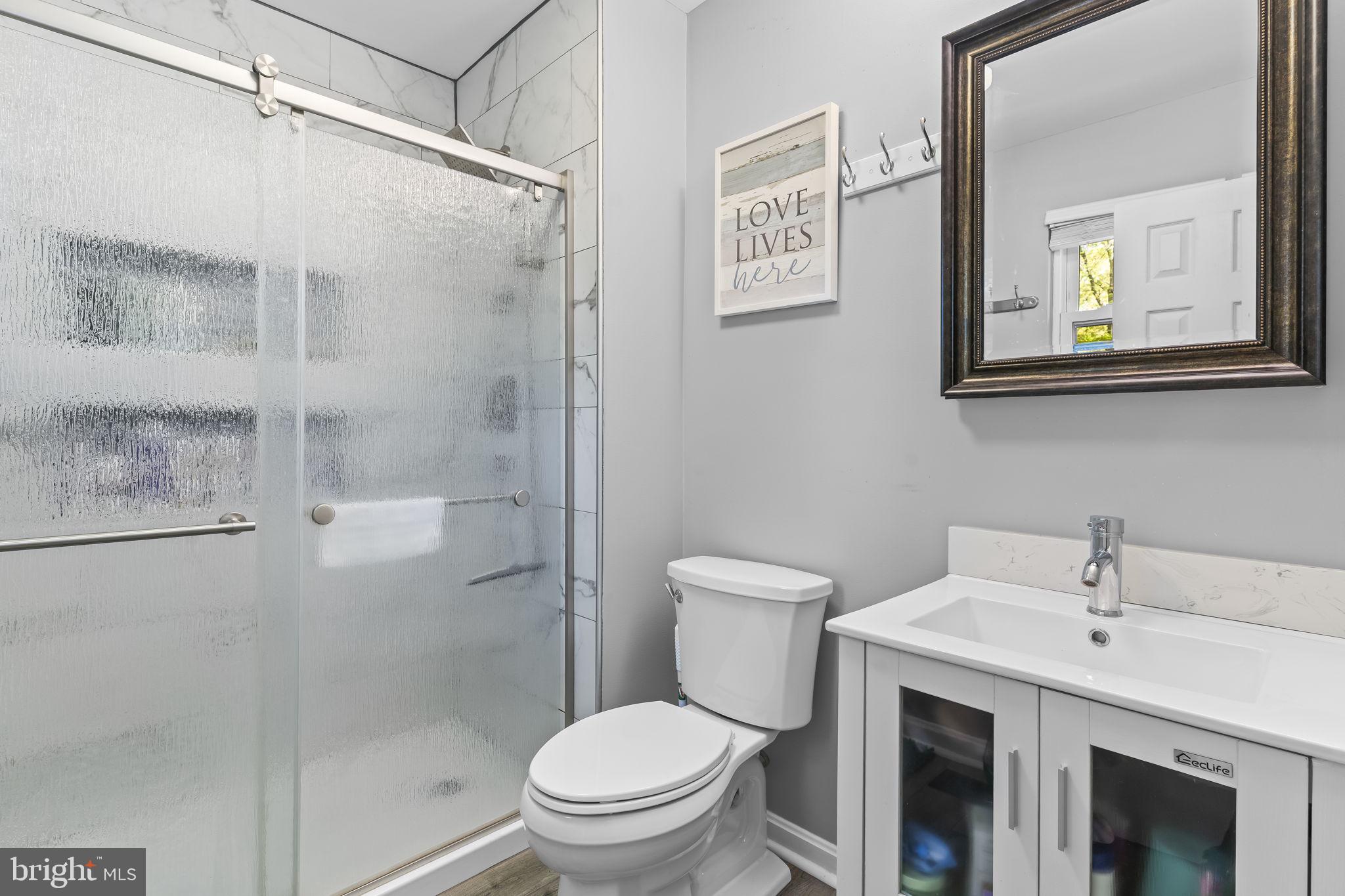 205 Pawnee Lane Lusby, MD 20657 - Photo 18 of 37 a bathroom with a toilet sink and shower