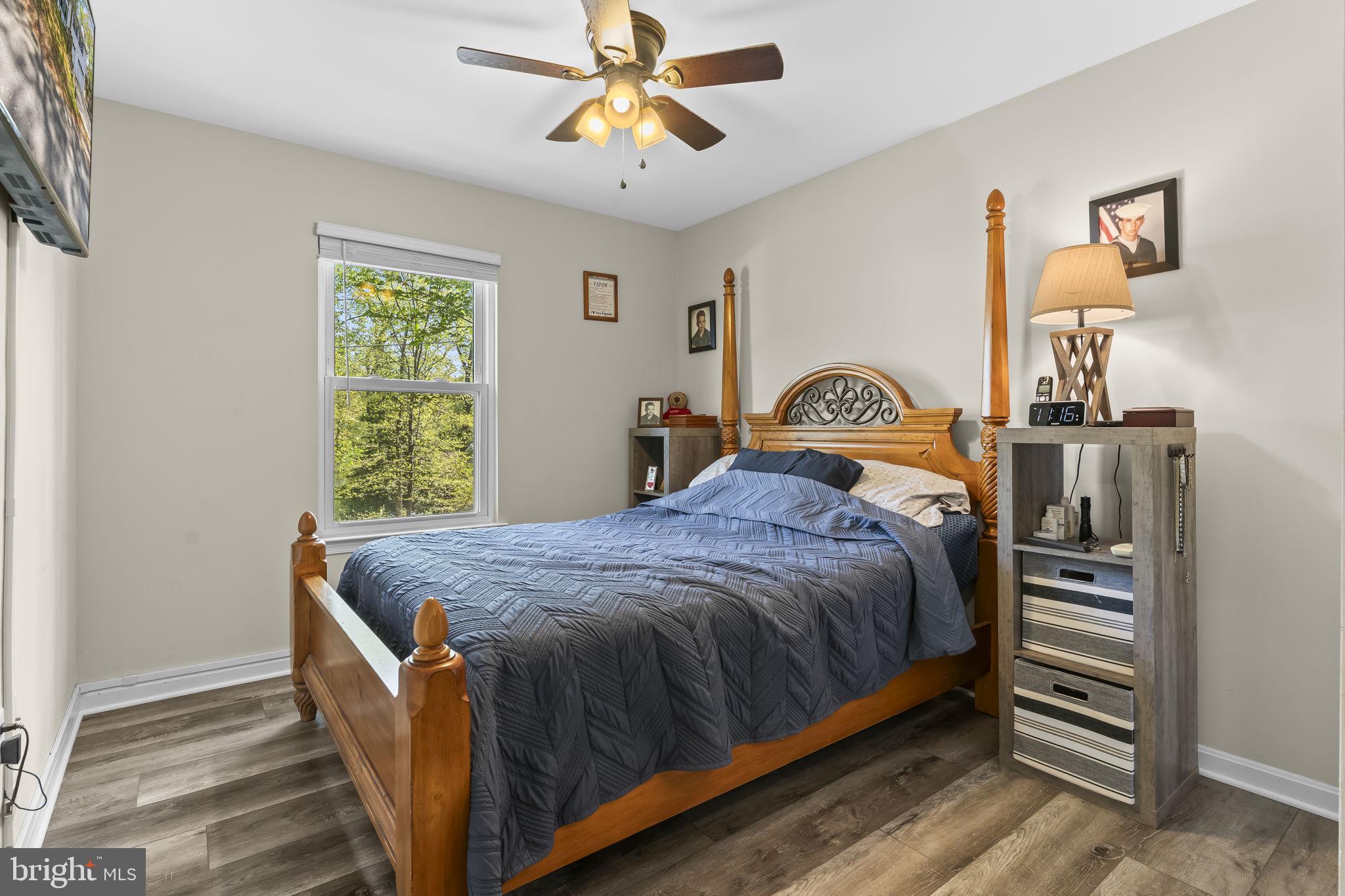 205 Pawnee Lane Lusby, MD 20657 - Photo 19 of 37 a bed sitting in a bedroom next to a window