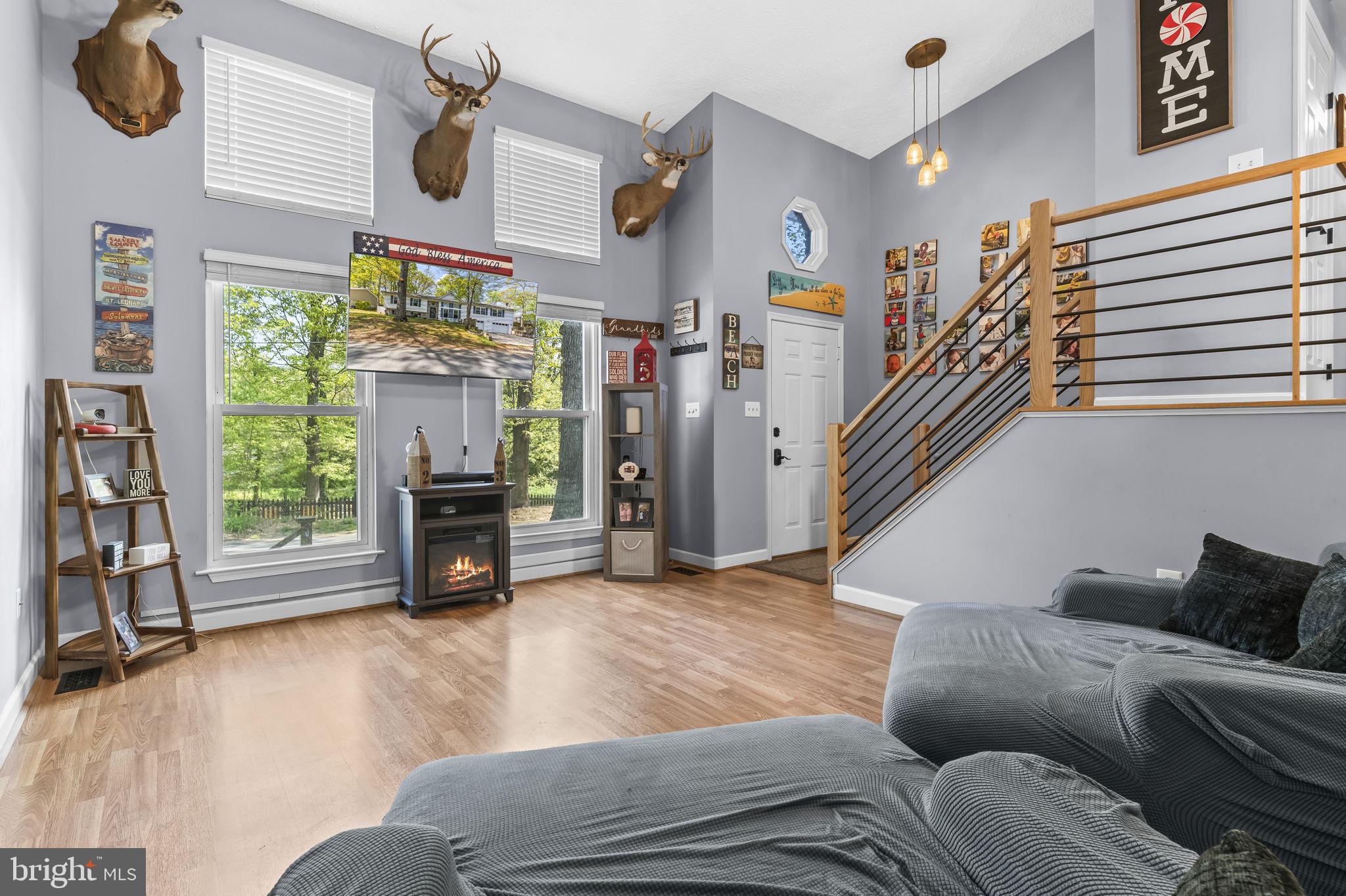 205 Pawnee Lane Lusby, MD 20657 - Photo 2 of 37 a living room with furniture and a fireplace