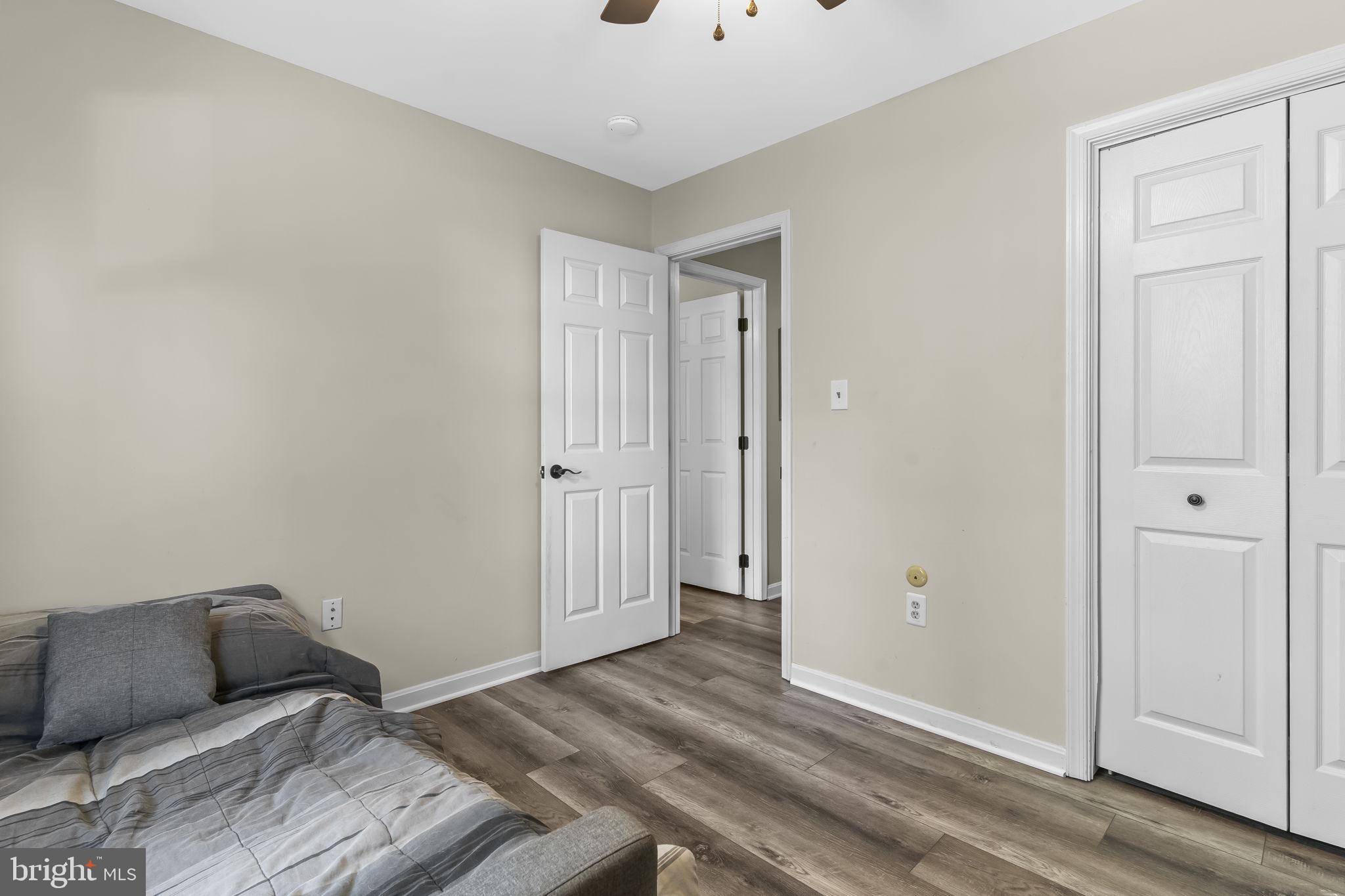 205 Pawnee Lane Lusby, MD 20657 - Photo 21 of 37 a bedroom with a bed and wooden floor
