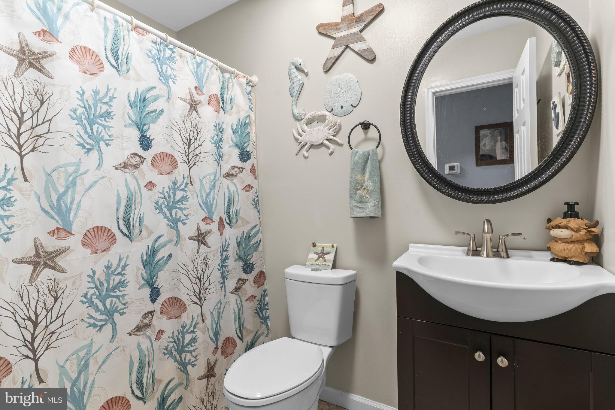 205 Pawnee Lane Lusby, MD 20657 - Photo 22 of 37 a bathroom with a toilet sink and mirror