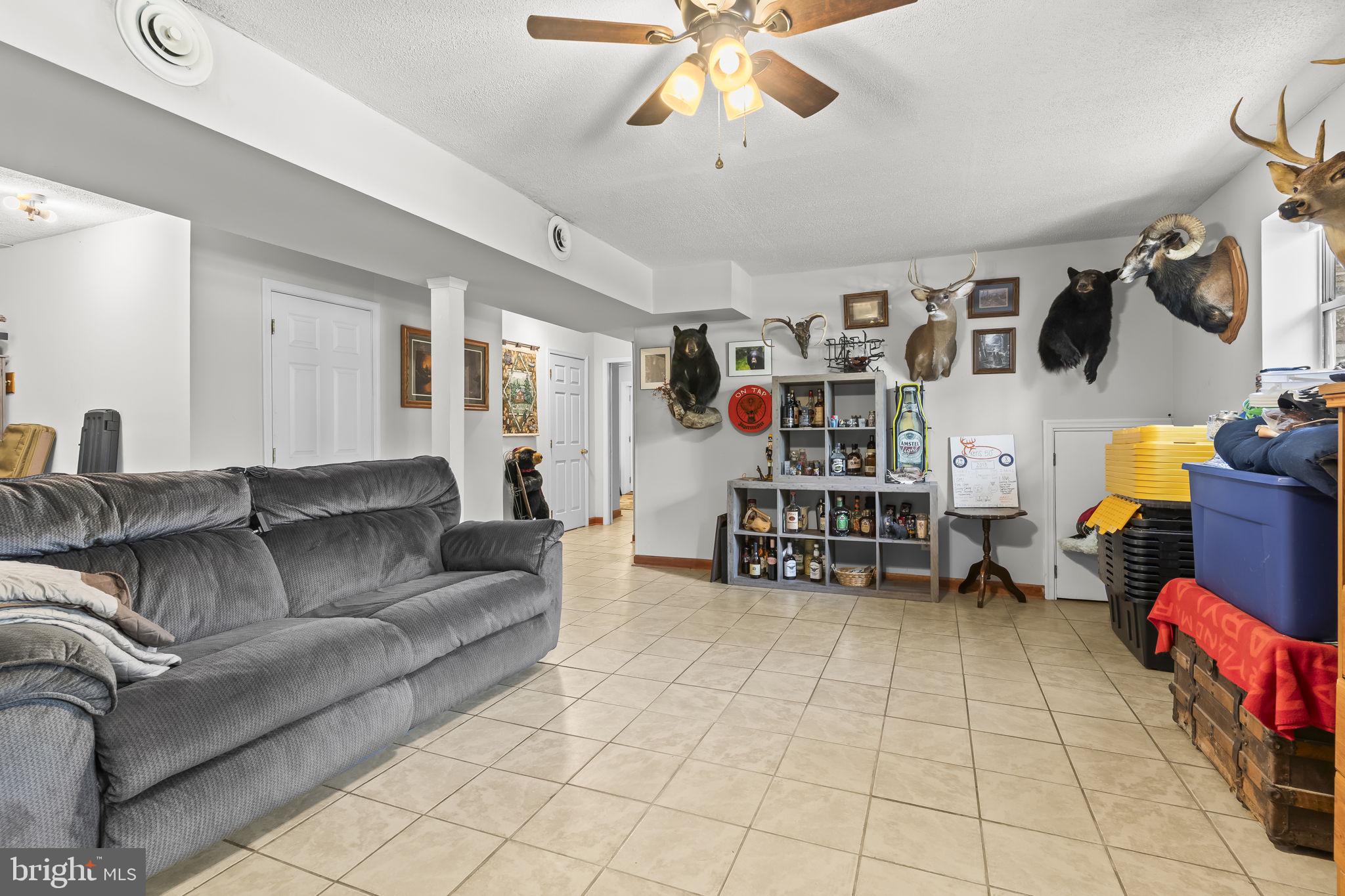 205 Pawnee Lane Lusby, MD 20657 - Photo 23 of 37 a living room with furniture and a flat screen tv