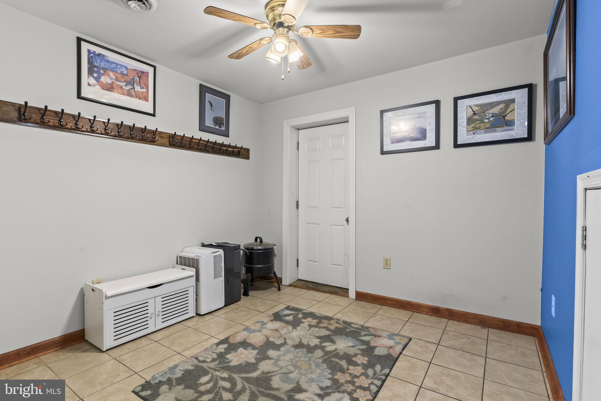 205 Pawnee Lane Lusby, MD 20657 - Photo 24 of 37 a view of a livingroom with workspace and a ceiling fan