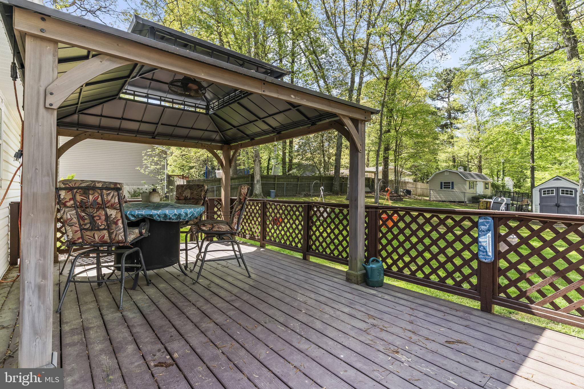 205 Pawnee Lane Lusby, MD 20657 - Photo 29 of 37 a view of a deck with wooden floor and outdoor seating