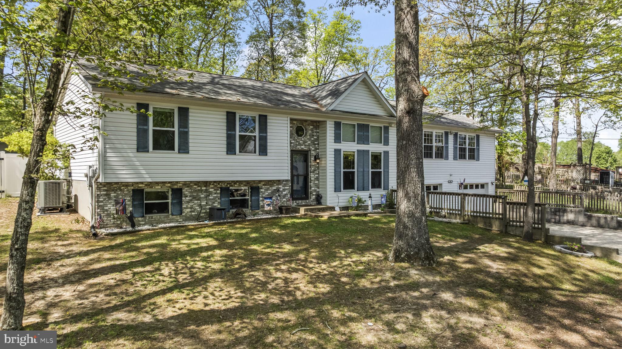 205 Pawnee Lane Lusby, MD 20657 - Photo 33 of 37 a view of a house with backyard porch and sitting area