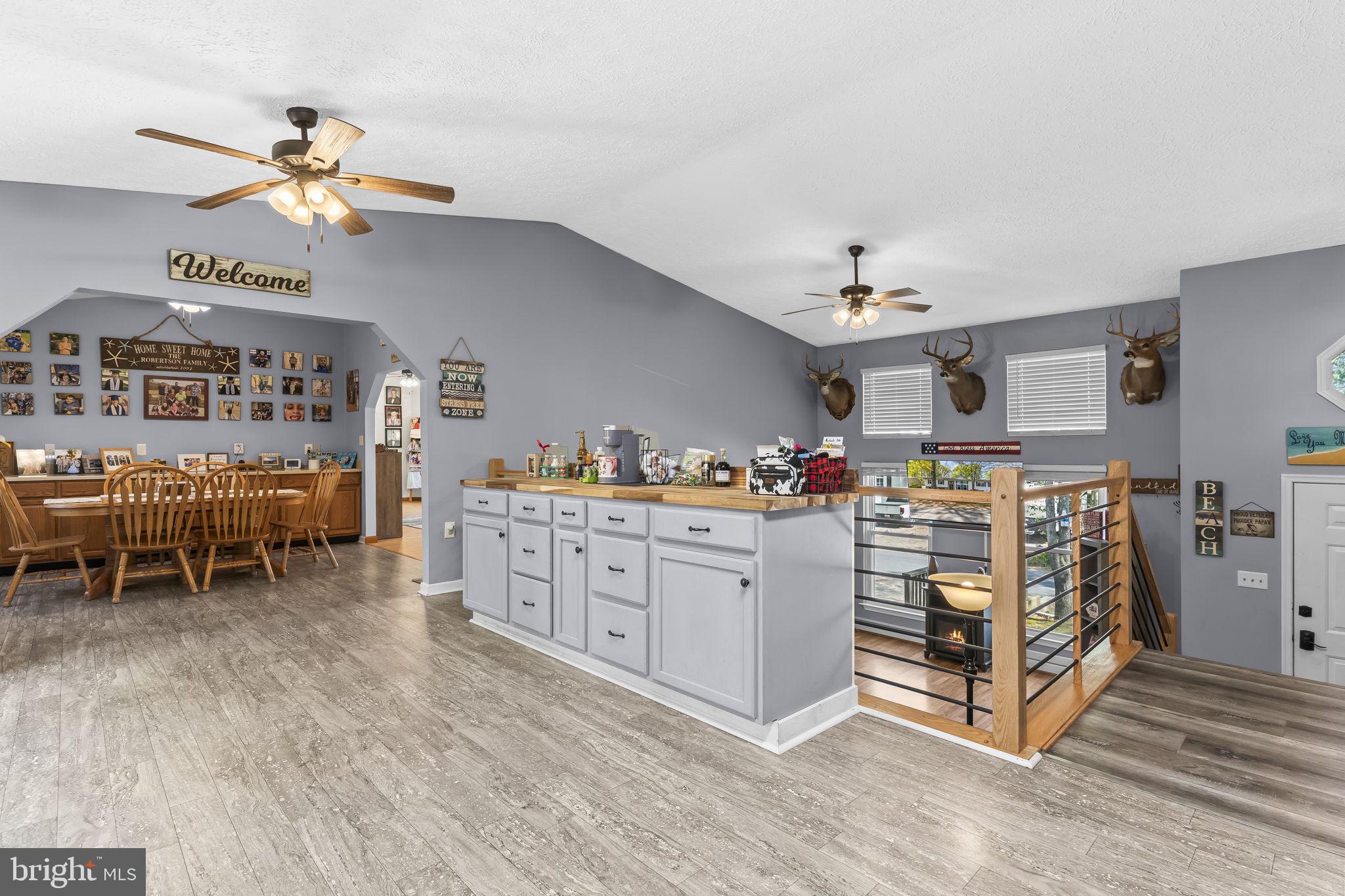 205 Pawnee Lane Lusby, MD 20657 - Photo 5 of 37 a living room with furniture and a chandelier