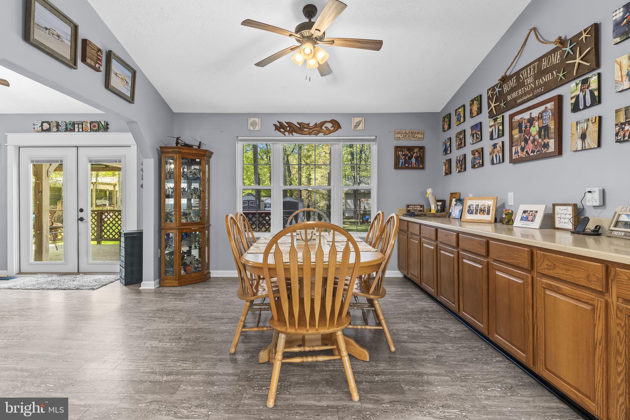 205 Pawnee Lane Lusby, MD 20657 - Photo 7 of 37 a dining room with furniture a chandelier and wooden floor