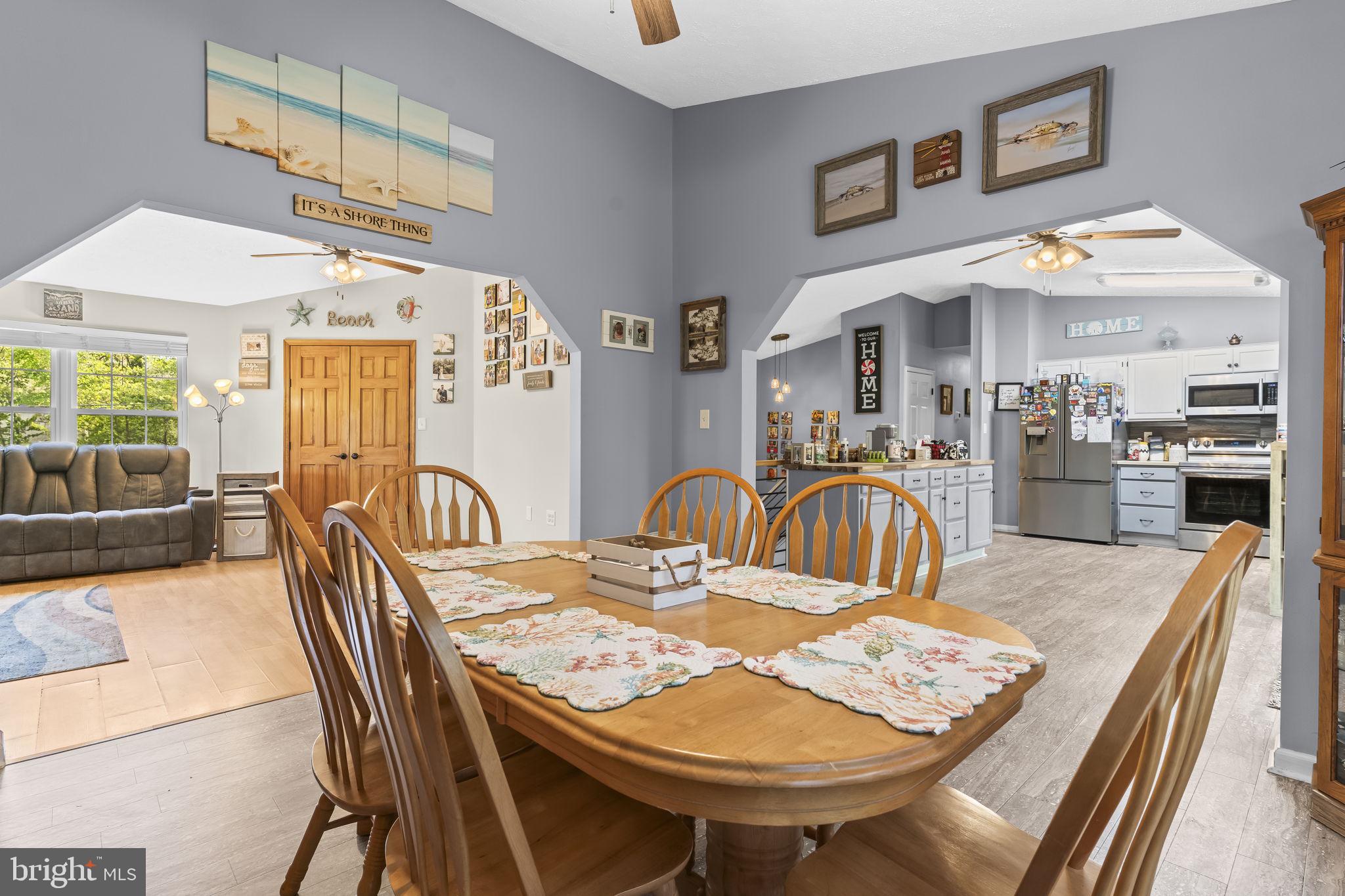 205 Pawnee Lane Lusby, MD 20657 - Photo 8 of 37 a view of a a dining room with furniture a chandelier and wooden floor