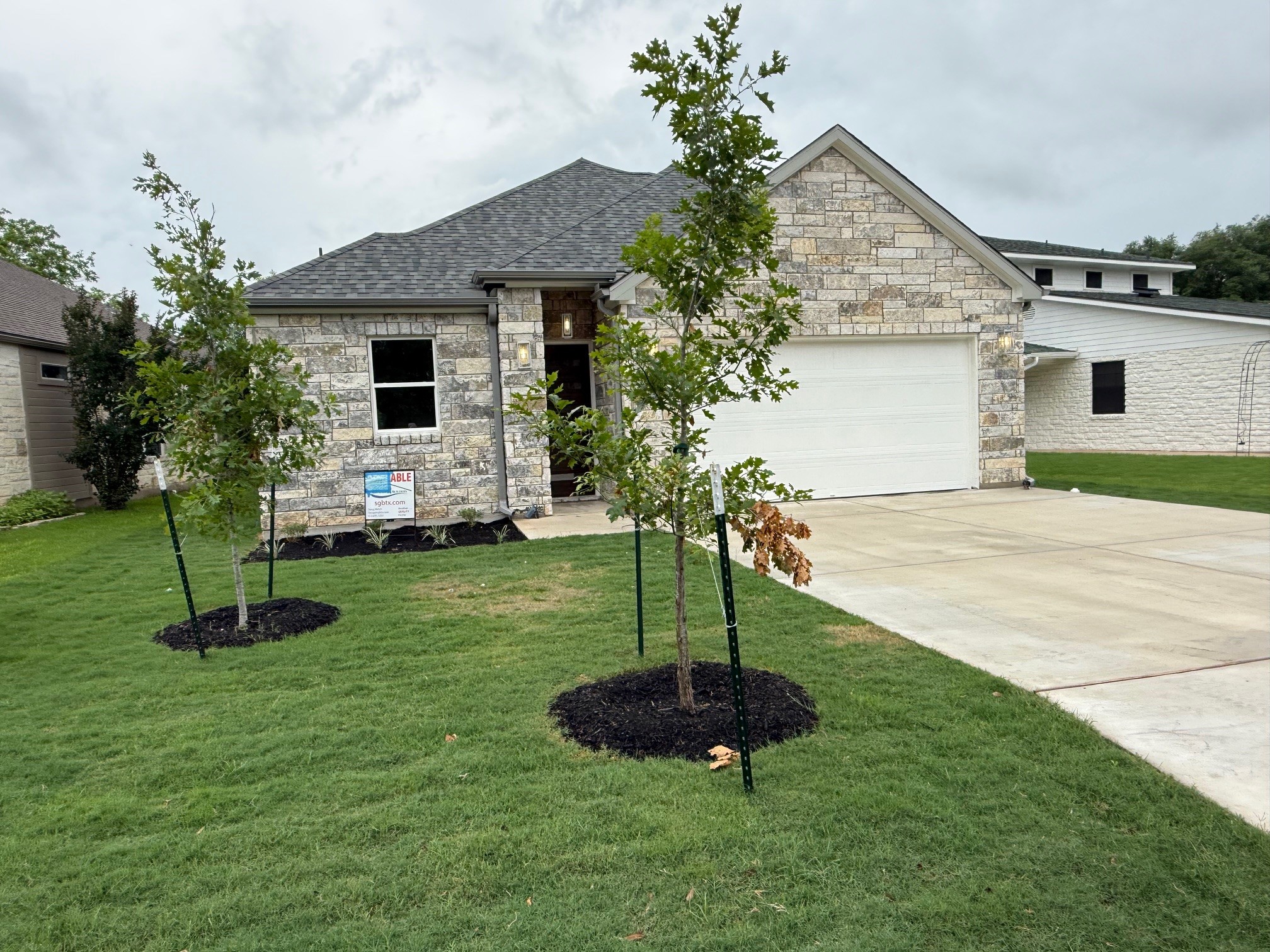 110 Firestone Place Meadowlakes, TX 78654 - Photo 2 of 18 Contemporary single-story residence showcasing a mixed material facade with light-colored stone veneer and horizontal siding