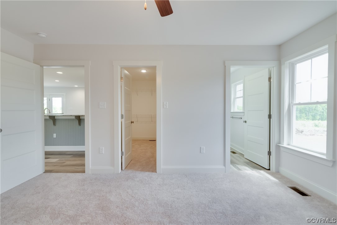 3315 Paynes Mill Road Bumpass, VA 23024 - Photo 19 of 28 an empty room with windows and entrance to other room