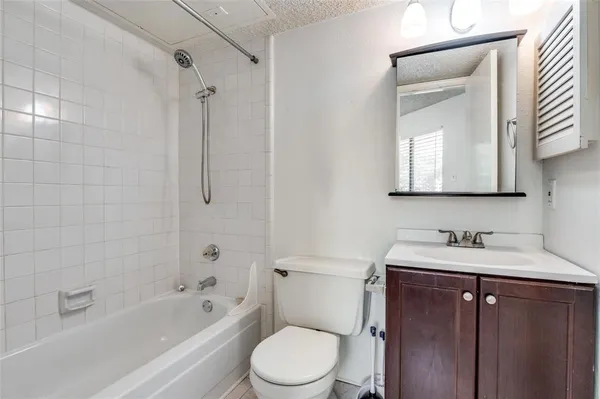 a bathroom with a sink toilet vanity and shower