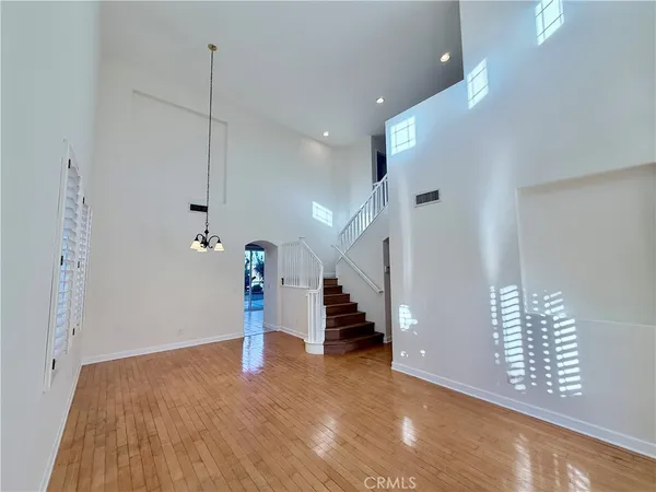 a view of an empty room with stairs and ventilation