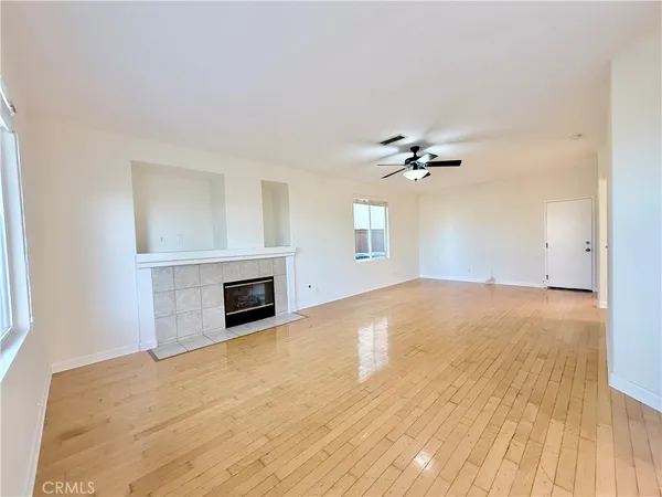 an empty room with a fireplace and windows