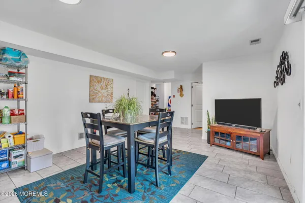 a view of a livingroom with furniture and a flat screen tv