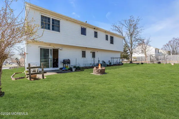 a view of a house with a backyard porch and sitting area